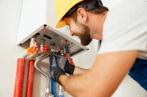 a repairman works on a furnace
