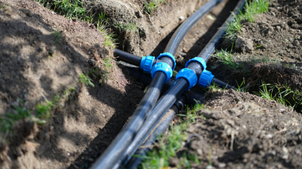 installed PVC water pipes in trench at summer home.